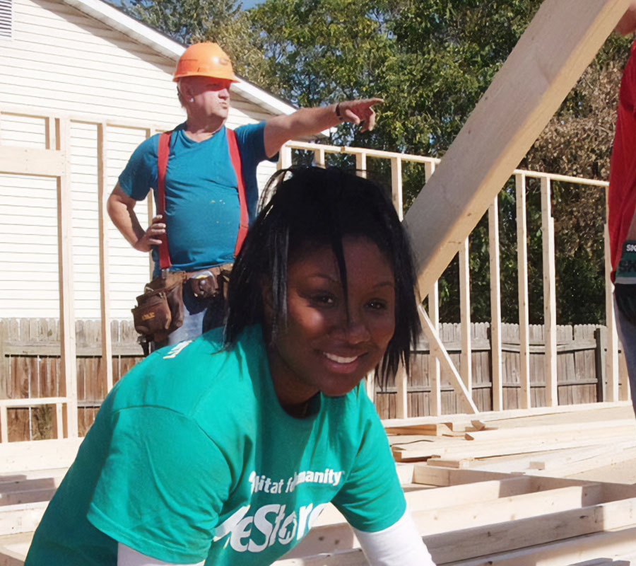young woman volunteering at a habitat for humanity build site