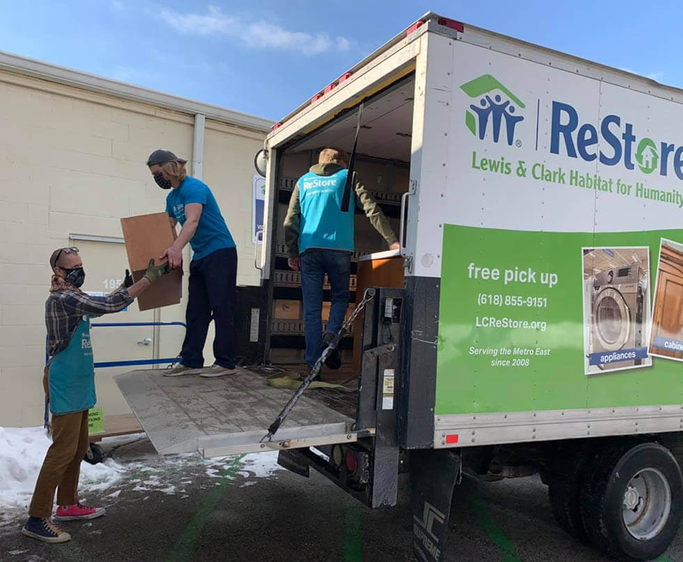 habitat for humanity restore volunteers unloading donations from a truck