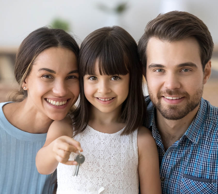 happy family holding house keys